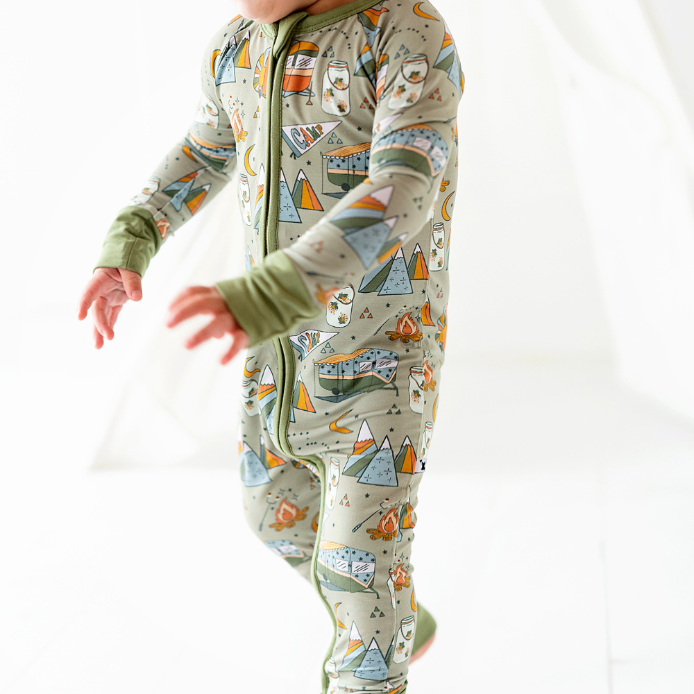 Baby wearing convertible footies with camping print
