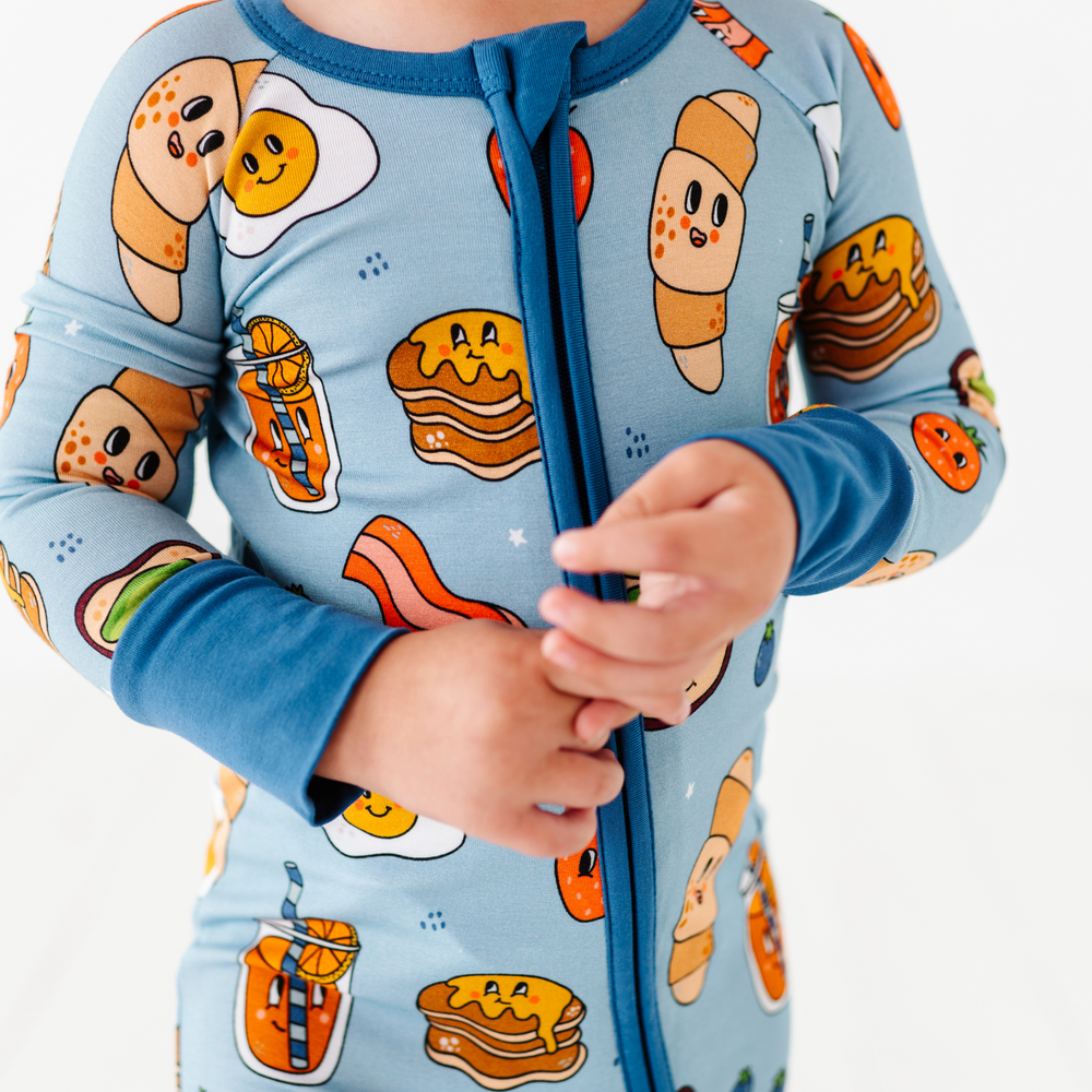 
                      
                        Baby in blue breakfast pajamas
                      
                    