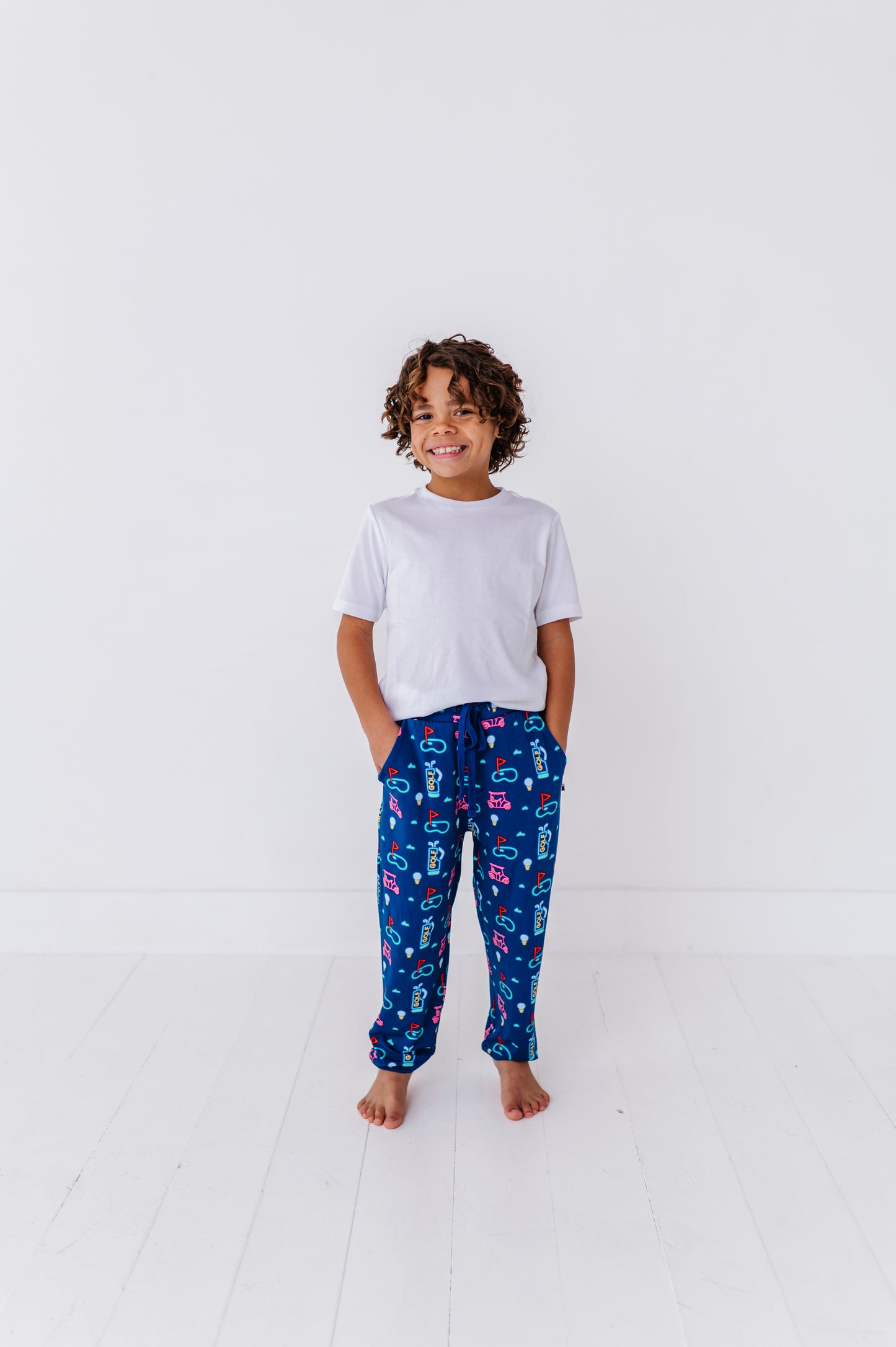 Boy Wearing Neon Golf Pajamas By Kiki Lulu