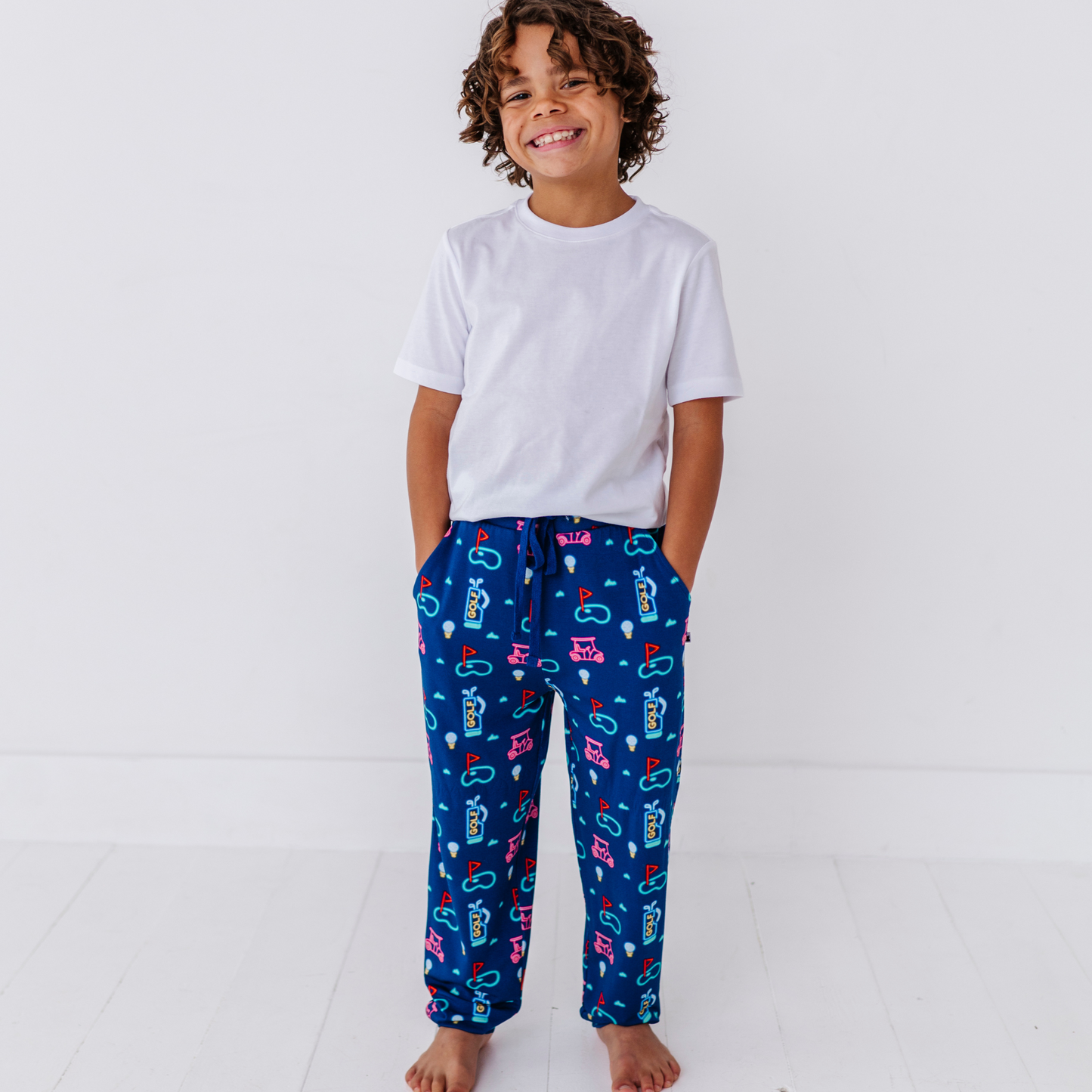 Boy in Neon Golf Pajamas By Kiki Lulu