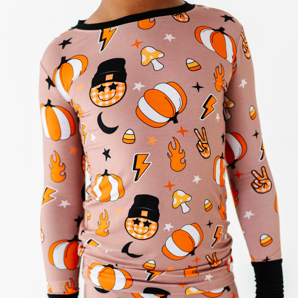 Boy wearing retro pumpkin pajamas by Kiki and Lulu