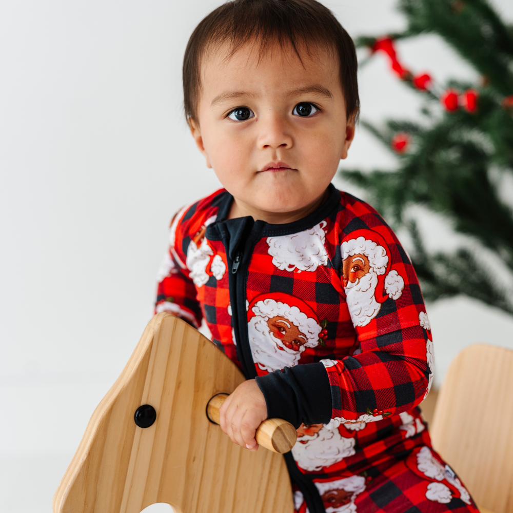 
                      
                        Baby in buffalo check santa pajamas by Kiki and Lulu
                      
                    