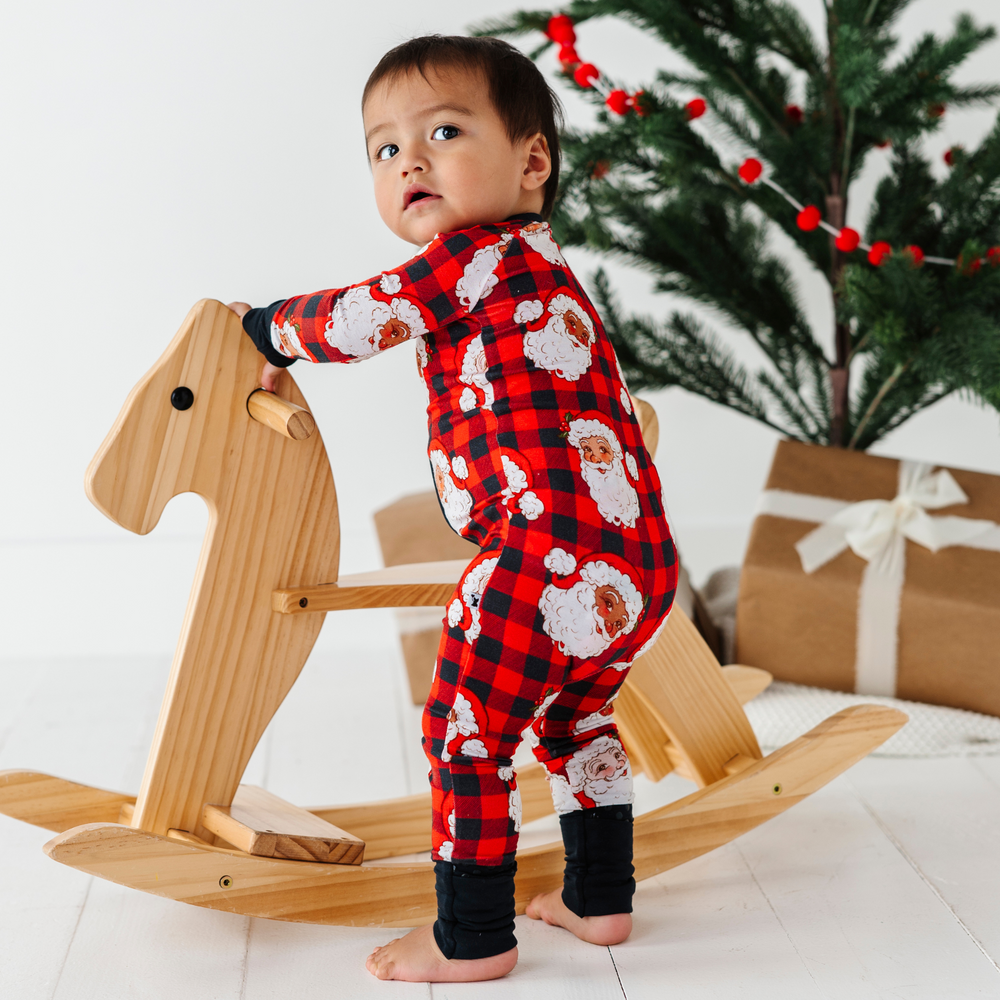 
                      
                        Baby in buffalo check santa pajamas by Kiki and Lulu
                      
                    