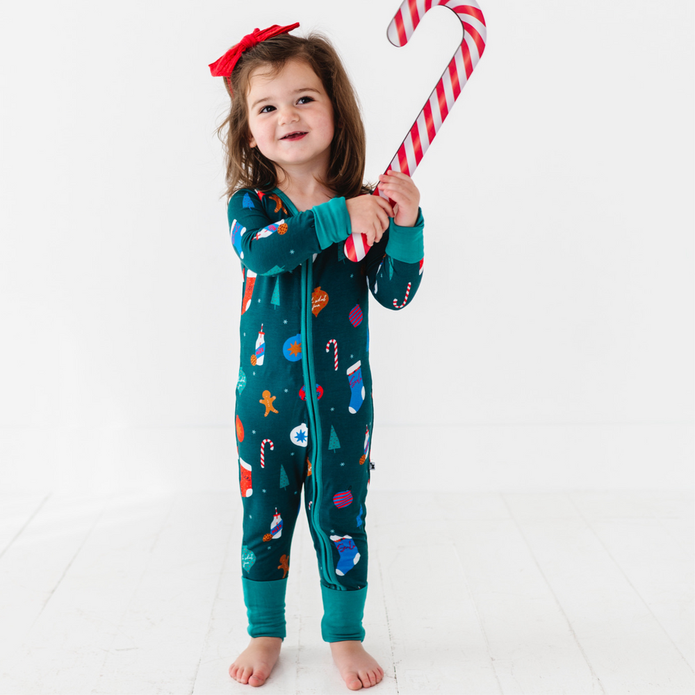 Girl in green Christmas footie pajamas by Kiki and Lulu