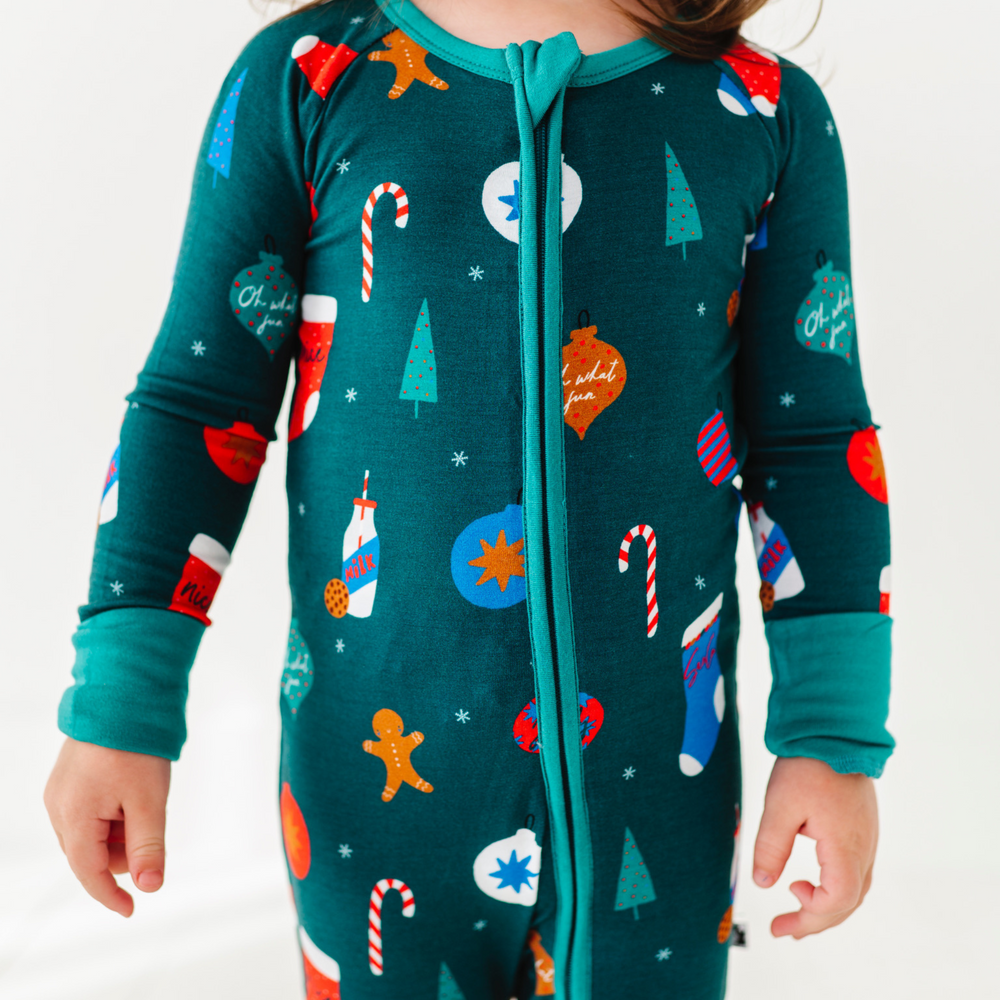 Girl in green Christmas footie pajamas by Kiki and Lulu