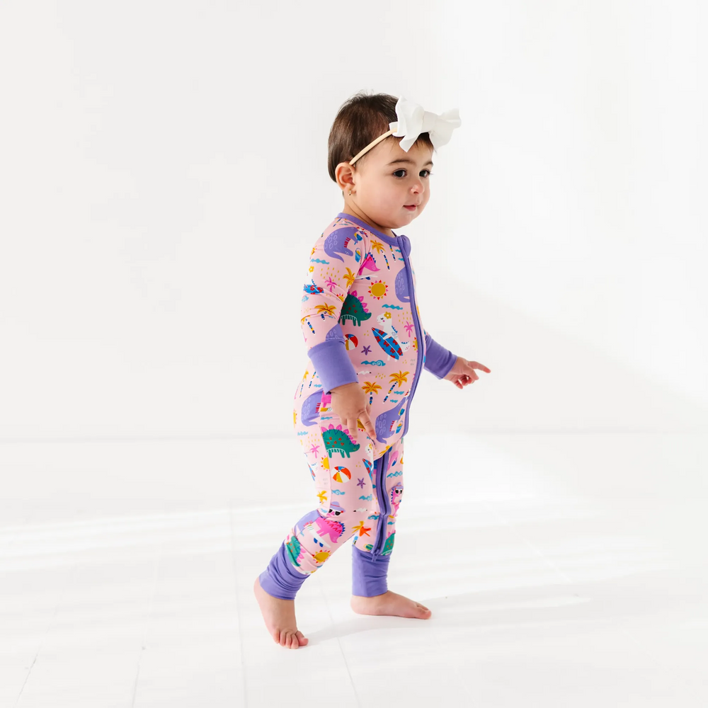 
                      
                        Baby Girl in dinosaur pajamas by Kiki and Lulu
                      
                    