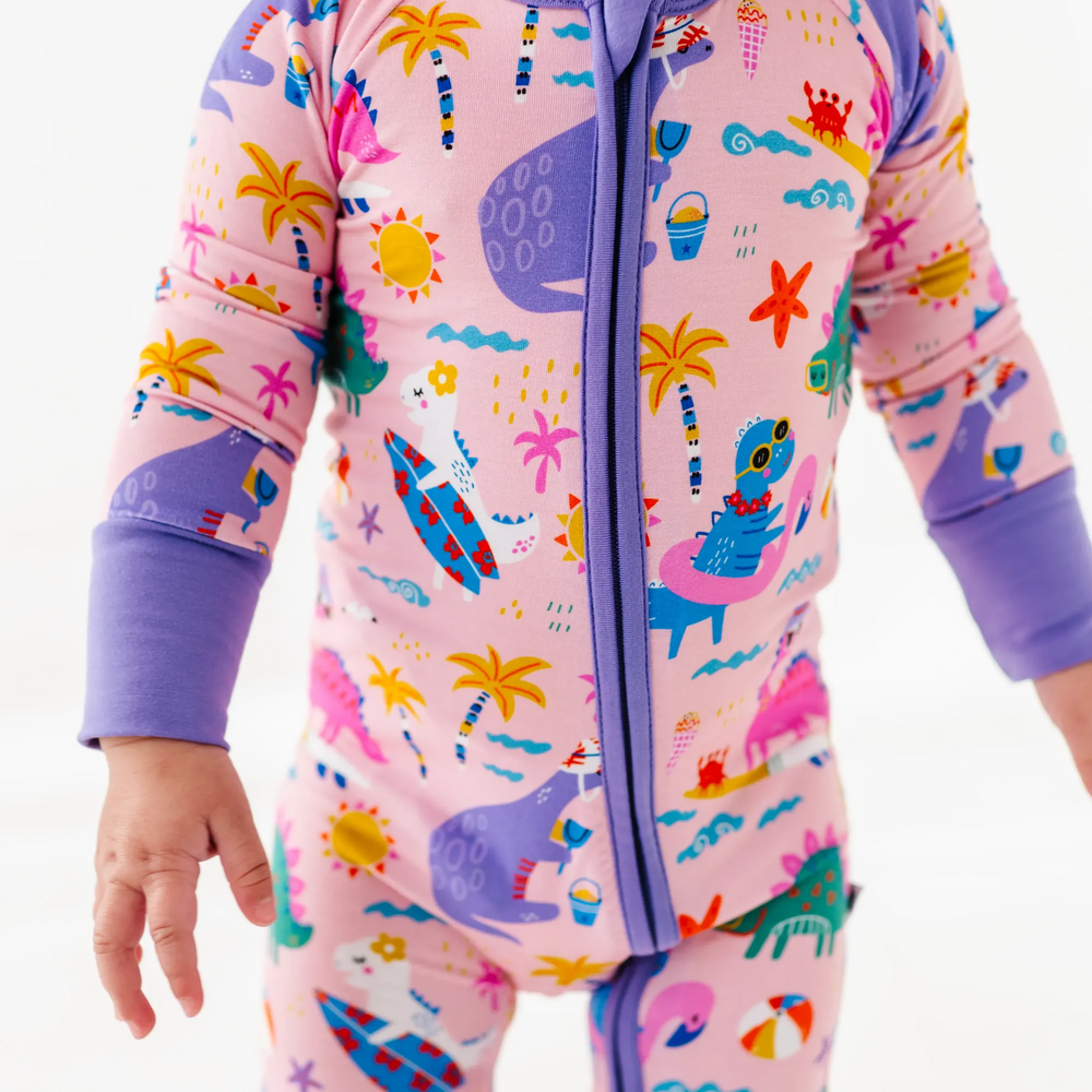 
                      
                        Baby Girl in dinosaur pajamas by Kiki and Lulu
                      
                    