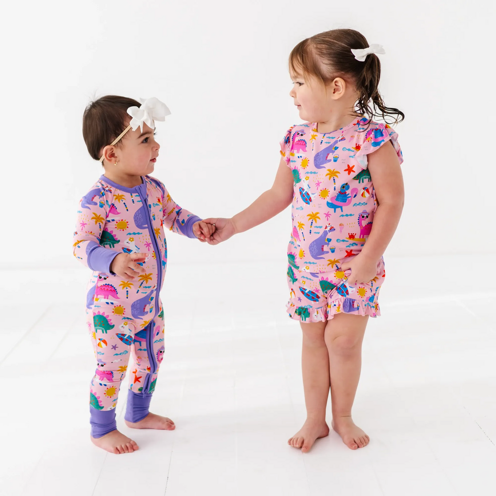 
                      
                        Baby Girl in dinosaur pajamas by Kiki and Lulu
                      
                    