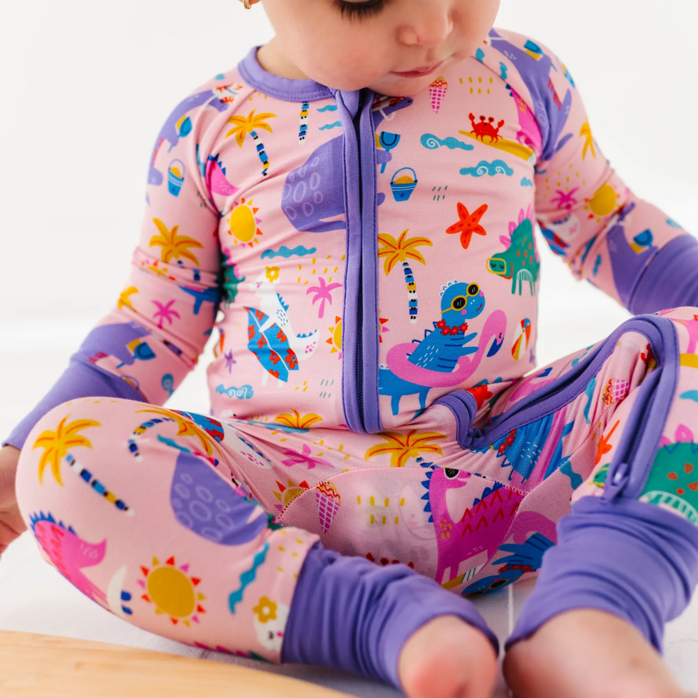 
                      
                        Baby Girl in dinosaur pajamas by Kiki and Lulu
                      
                    