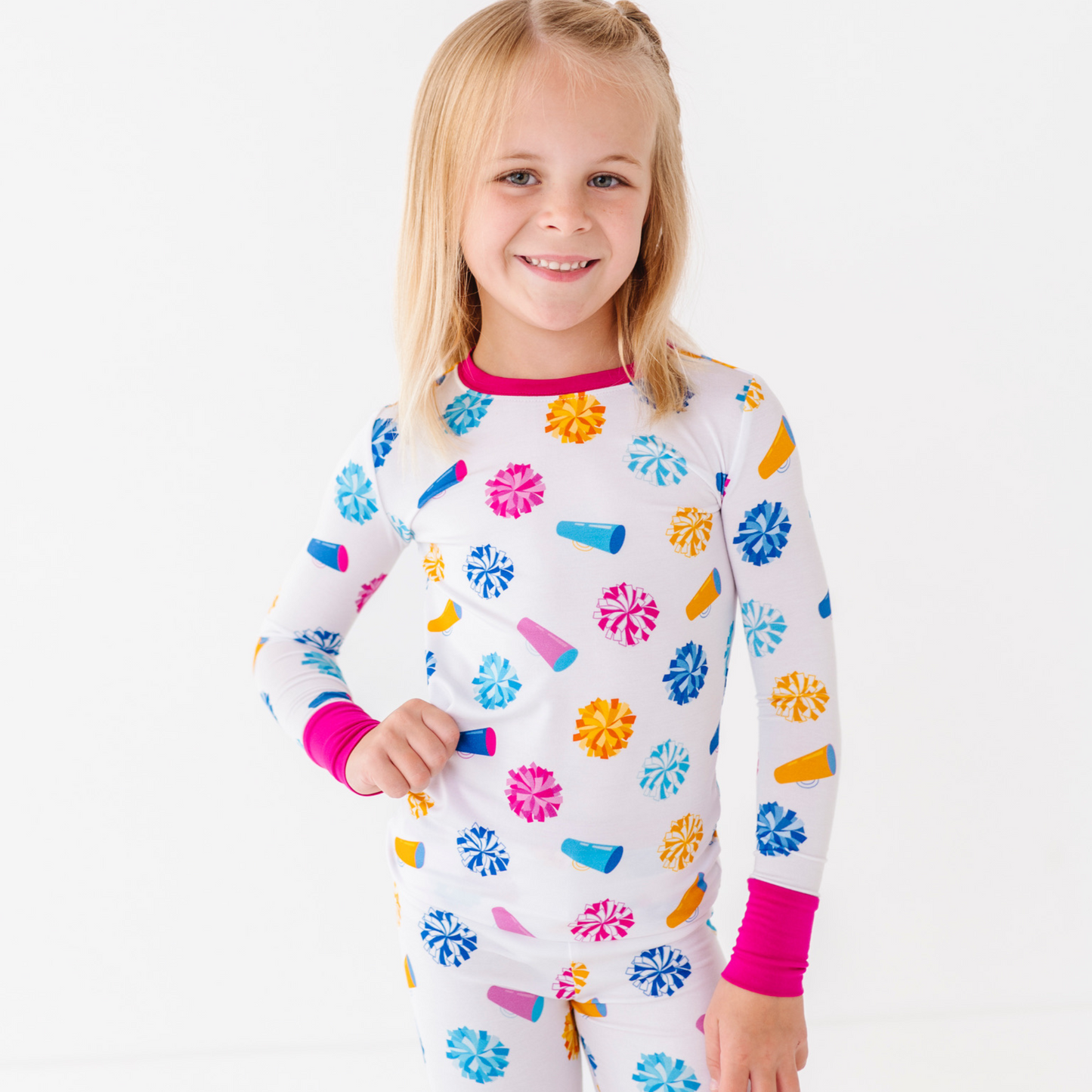 Child wearing a colorful pajama set with a white background