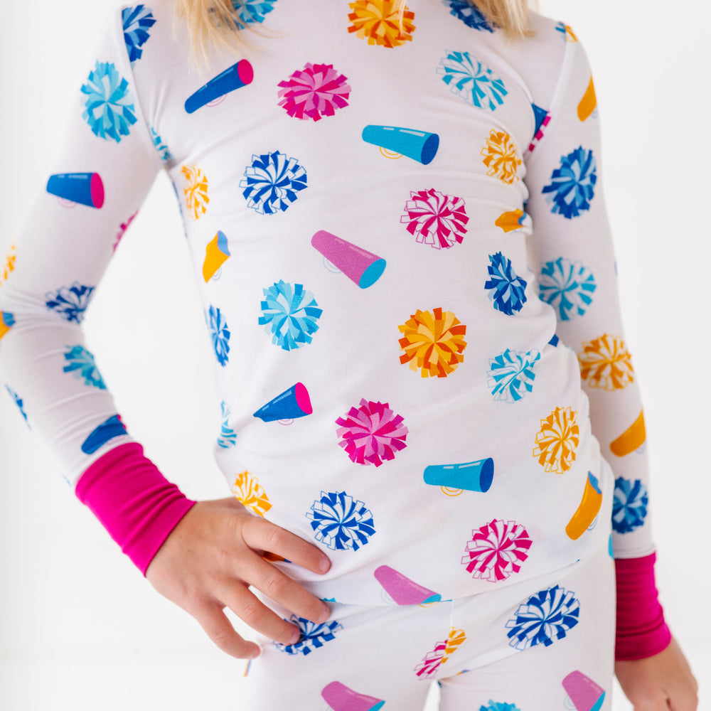 Child wearing a colorful pajama set with a white background