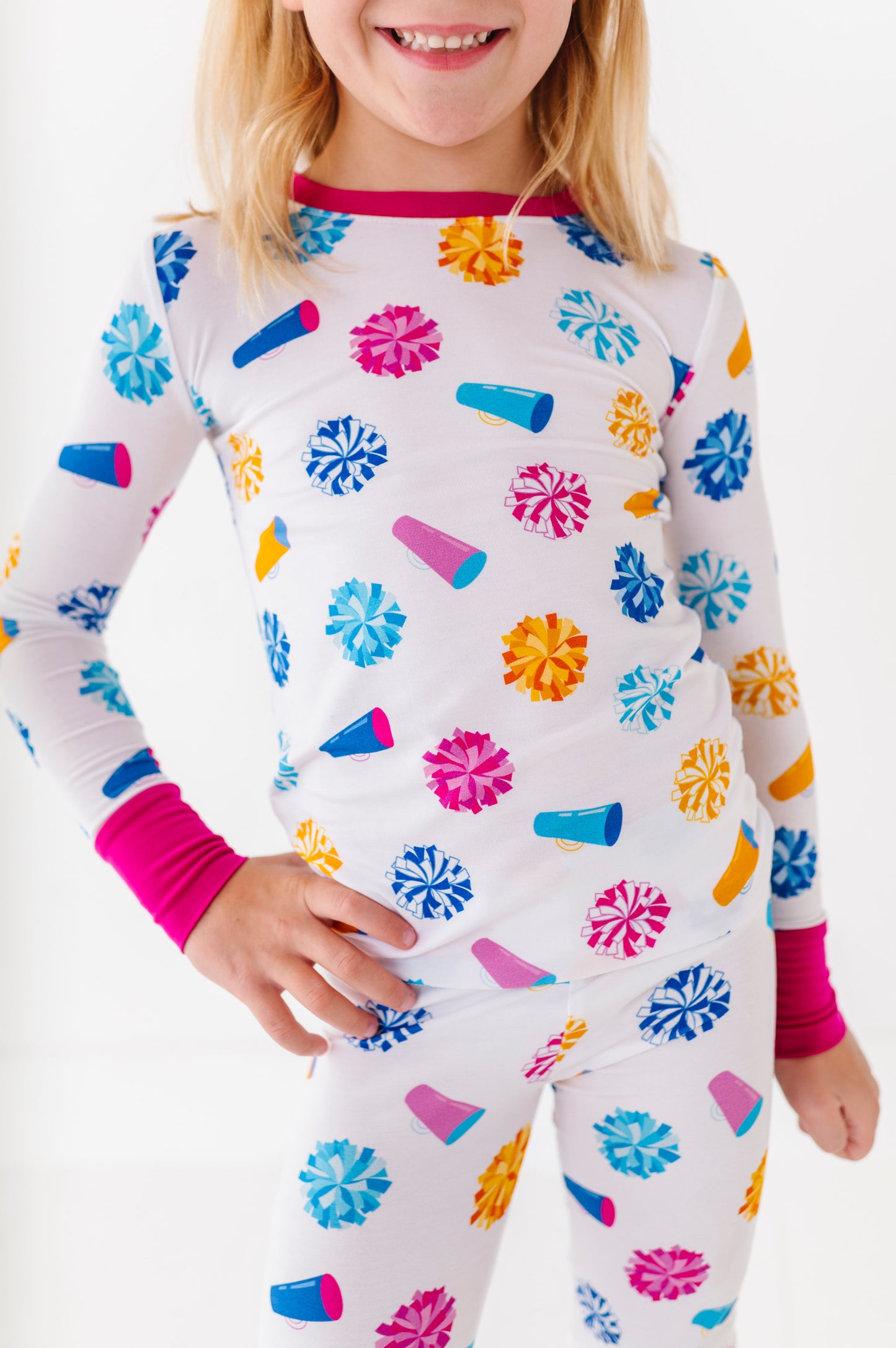 Child wearing a colorful pajama set with a white background