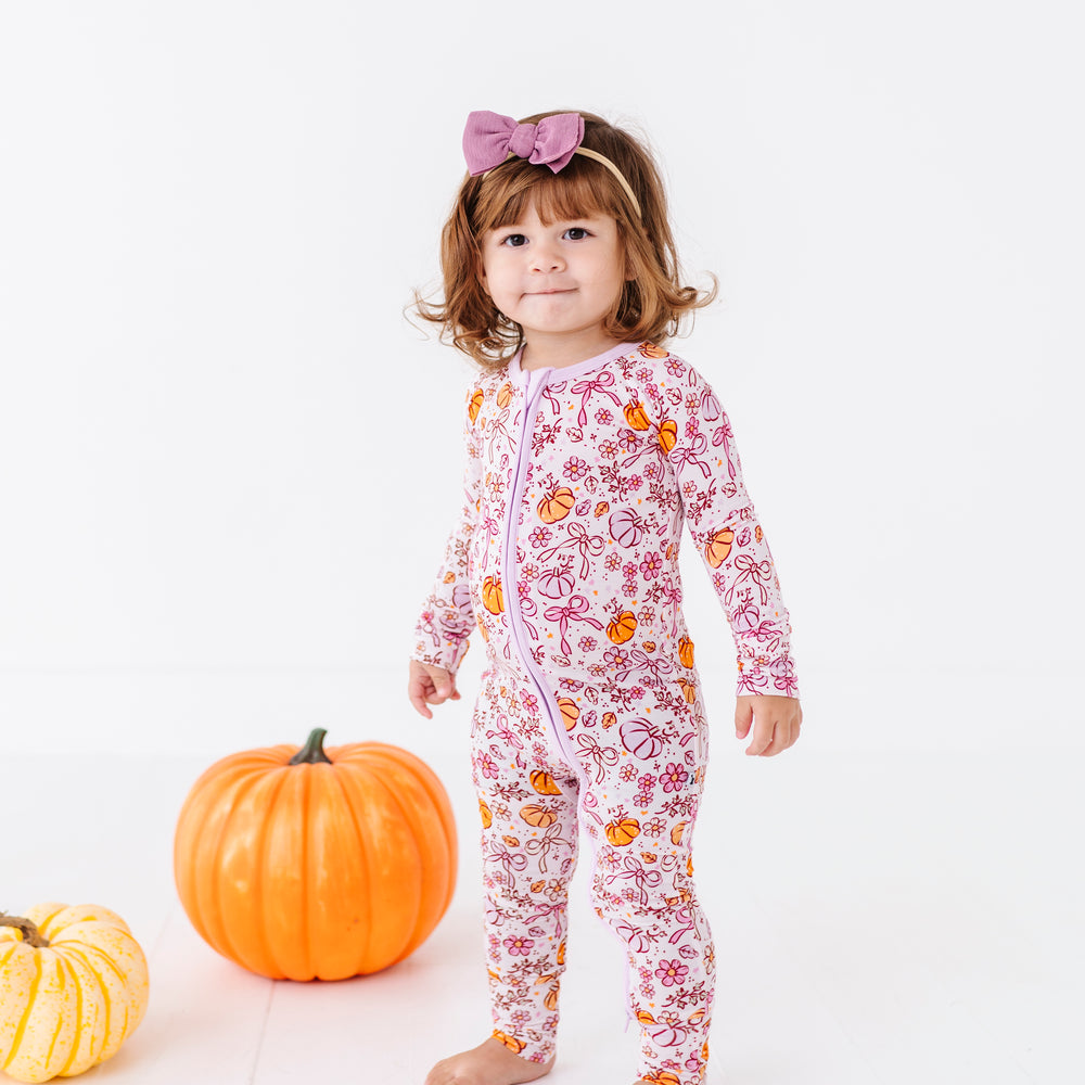
                      
                        Girl in Purple Pumpkin and Bow Footies
                      
                    