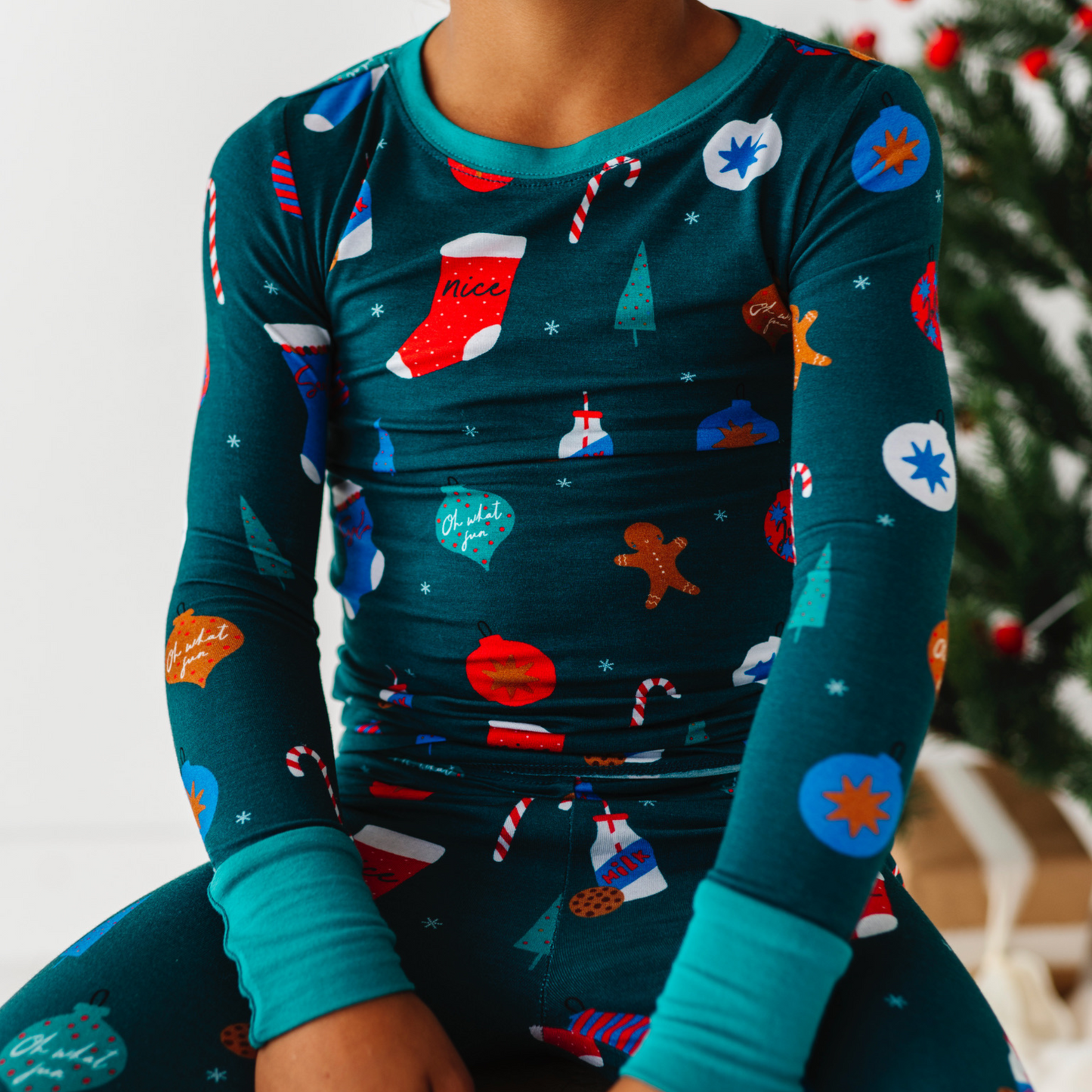 Boy in Green Christmas pajamas by Kiki and Lulu