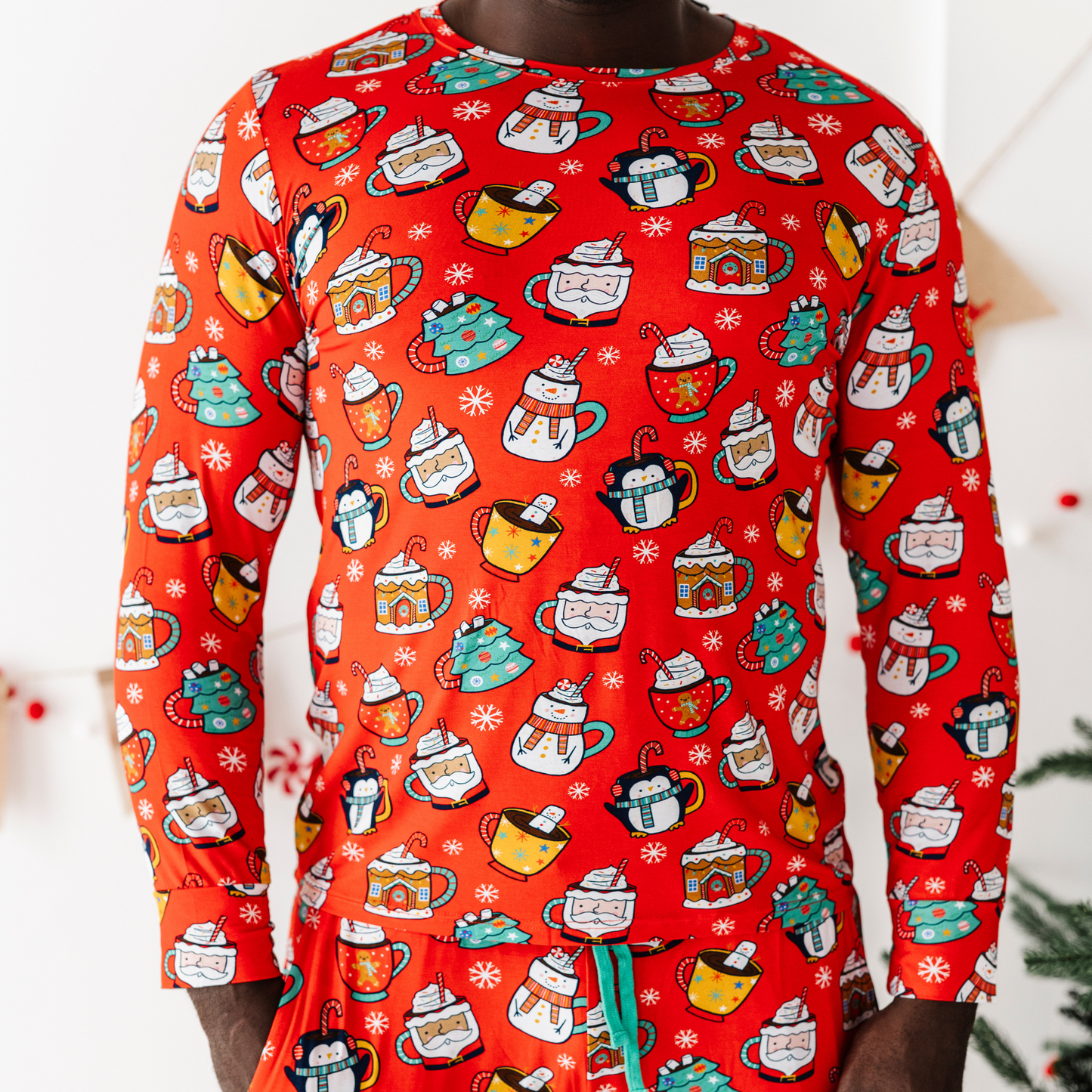 Man in family matching Christmas cocoa pajamas