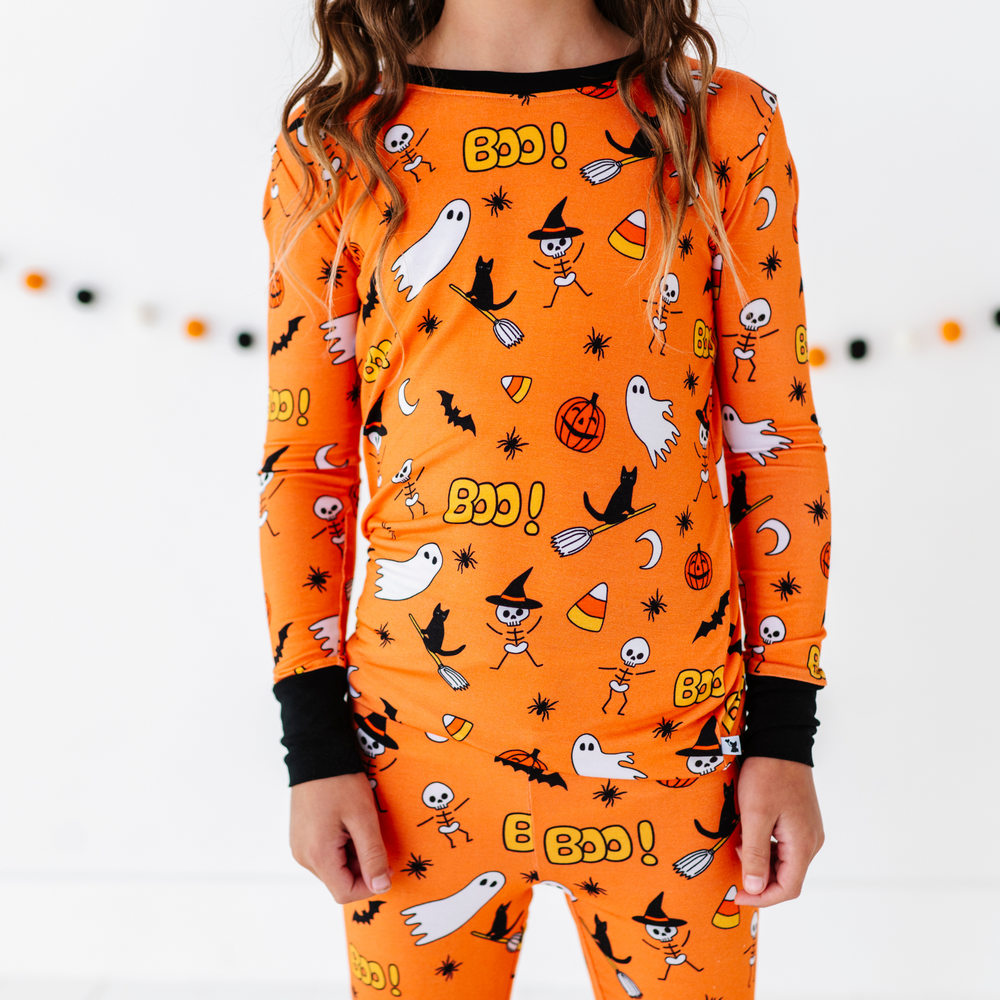 Girl in orange Halloween Pajamas