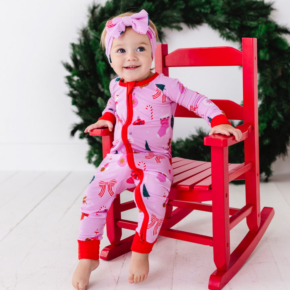 Baby in Pink Christmas pajamas by Kiki and Lulu