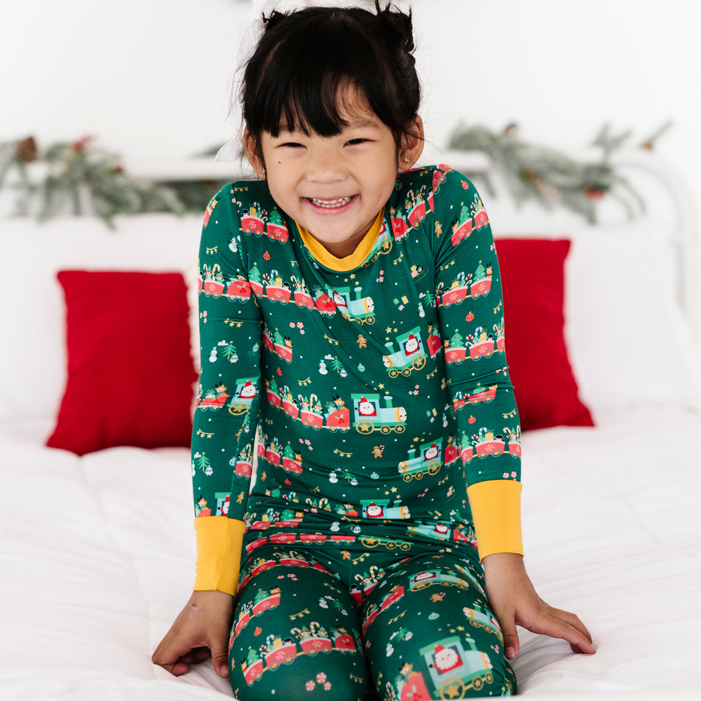 
                
                    Load image into Gallery viewer, Toddler in Christmas train pajamas 
                
            