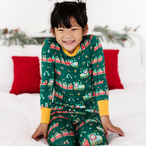 
                
                    Load image into Gallery viewer, Toddler in Christmas train pajamas 
                
            